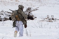 Sgt. James Luce, assigned to Charger Company, 1st Battalion, 5th Infantry Regiment, 1st Stryker Brigade Combat Team, 25th Infantry Division, U.S. Army Alaska, signals to his Soldiers to advance during Operation Punchbowl at Joint Base Elmendorf-Richardson, Alaska, Feb. 10, 2018. Operation Punchbowl was a battalion-level, combined arms, live-fire exercise that focused on arctic lethality. During the operation three 150-Soldier companies maneuvered through varied terrain; attacking and seizing enemy positions as well as eliminating key weapons and vehicles being utilized by the enemy. (U.S. Air Force photo by Alejandro Peña). Original public domain image from Flickr