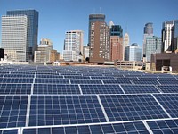 The 600kw solar electric system installation on the Minneapolis convention center. local installers inspecting PV panels that are part of the district energy St. Paul solar thermal project. Original public domain image from Flickr