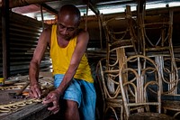 Man making a rattan furniture, Palawan, Philippines, July 2017.