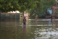 A boy negotiates flood waters in Beletweyne, Somalia, on May 27, 2016. Beletweyne is currently experiencing its worst flooding since 1981 and over 17,000 people have already been displaced. AMISOM Photo / Tobin Jones. Original public domain image from Flickr