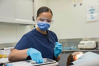 MEDITERRANEAN SEA (June 29, 2016) – Hospitalman Rachel Folwell begins a dental cleaning on Legalman 1st Class Renae Palache in the dental clinic aboard the aircraft carrier USS Dwight D. Eisenhower (Ike).