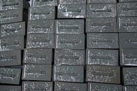 Snow falls on ammunition cans lined up on the ground as Airmen. Original public domain image from Flickr