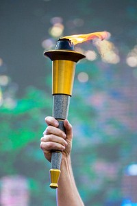 U.S. Navy Vice Adm. Dixon Smith, the commander of Navy Installations Command, holds the Department of Defense Warrior Games torch during closing ceremonies for the games at the U.S. Military Academy in West Point, N.Y. June 21, 2016.