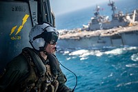 U.S. Navy Aircrewman (Helicopter) 2nd Class Eric Smith rides in an MH-60S Seahawk helicopter, attached to the &ldquo;Blackjacks&rdquo; of Helicopter Sea Combat Squadron (HSC) 21, during composite training unit exercise (COMPTUEX) in the Pacific Ocean, June 11, 2018.