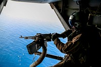 5TH FLEET AREA OF OPERATIONS (May 11, 2018) ..U.S. Marine Corps Staff Sgt. Jason Bradtmueller, an MV-22B Osprey crew chief with Marine Medium Tiltrotor Squadron (VMM) 162 (Reinforced), 26th Marine Expeditionary Unit (MEU), fires an M240B machine gun at a simulated target during an aerial gunnery instructor certification in the 5th fleet area of operations, May 11, 2018.