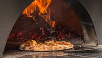 Timber Pizza Company wood fire mobile brick oven creates intense heat that cooks pizza in minutes at the U.S. Department of Agriculture (USDA) Farmers Market, in Washington, D.C. Original public domain image from Flickr