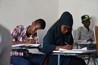 Secondary students take their national examinations in Mogadishu, Somalia, on 22 May 2018. Original public domain image from <a href="https://www.flickr.com/photos/au_unistphotostream/28491773118/" target="_blank">Flickr</a>