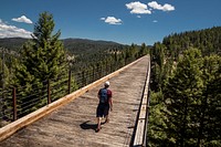 A man makes his way across a former railroad trestle as he hikes the former Milwaukee Railroad Trail in the Thompson Park area of Beaverhead-Deerlodge National Forest.