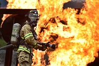 Fire protection specialist Senior Airman Larry Kyles, a native of Dallas, Texas, assigned to the 673rd Civil Engineer Squadron, performs firefighter training on a simulated aircraft fire at Joint Base Elmendorf-Richardson, Alaska, Wednesday, Sept. 14, 2016. Aircraft live fire training is conducted periodically throughout the year at JBER to ensure Airmen are prepared to combat aircraft fuel fires. (U.S. Air Force photo/Justin Connaher). Original public domain image from Flickr