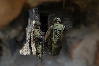 German army infantrymen with the 391st Mechanized Infantry Battalion plan their next maneuver in a recently secured building at Vaziani Training Area, Georgia, Aug. 5, 2018.