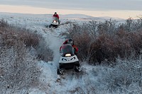 U.S. Marine Corps 1st Sgt. Joshua Guffey, foreground, and Capt. Michael Sickels, assigned to Detachment Delta, 4th Law Enforcement Battalion, travel via snow machine from Buckland to Deering, Alaska, Nov. 29, 2016. Original public domain image from Flickr