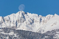 The moon "touches" the summit of Electric Peak. Original public domain image from Flickr