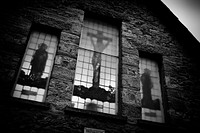 Church in monotone background, God on the cross seeing through stained glass window. Original public domain image from Flickr