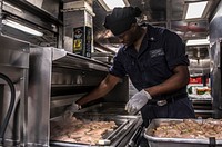MEDITERRANEAN SEA (Dec. 31, 2018) &ndash; Culinary Specialist 2nd Class Edward Collins grills chicken aboard the Arleigh Burke-class guided-missile destroyer USS Porter (DDG 78) in the Mediterranean Sea, Dec. 31, 2018.