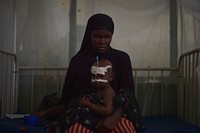 A malnourished child sits on his mother's lap at Banadir hospital in Mogadishu, Somalia, on March 9, 2017.