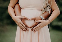 Pregnant lady holding belly. Free public domain CC0 photo.