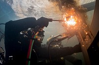 U.S. Navy Equipment Operator 3rd Class Thomas Dahlke, assigned to Underwater Construction Team 2, cuts a piece of steel in a training pool at the Republic of Korea (ROK) Naval Education and Training Command during exercise Foal Eagle in Jinhae, South Korea, March 31, 2017.