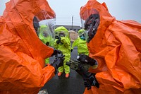 Survey team members Sgts. Joseph Bercovic, right, and Cory Sweetman, both with the New Jersey National Guard's 21st Weapons of Mass Destruction-Civil Support Team, check their chemical and radiation detection gear as Monmouth County Hazmat team members finish suiting up during a joint training exercise at Fort Monmouth, N.J., April 6, 2017. The 21st WMD-CST is a joint unit comprised of New Jersey National Guard Soldiers and Airmen whose mission is to support civil authorities by identifying chemical, biological, radiological, and nuclear substances in either man-made or natural disasters. (New Jersey National Guard photo by Mark C. Olsen/Released). Original public domain image from Flickr