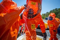 Survey team members with the 21st Weapons of Mass Destruction-Civil Support Team (WMD-CST), New Jersey National Guard, are decontaminated after leaving a simulated crime scene during an Army North mandated training proficiency evaluation at Naval Weapons Station Earle, Colts Neck, N.J., April 23, 2019. The 21st WMD-CST supports civil authorities at man-made or natural disasters by identifying chemical, biological, radiological, and nuclear substances, as well as assess the consequences, advises on response measures, and assists in requesting follow-on forces. (New Jersey National Guard photo by Mark C. Olsen). Original public domain image from Flickr