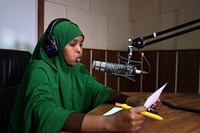 A journalism student practices radio presentation at Radio Himilo of the Mogadishu University in Somalia on April 30, 2017. AMISOM Photo / Ilyas Ahmed. Original public domain image from <a href="https://www.flickr.com/photos/au_unistphotostream/34429844456/" target="_blank" rel="noopener noreferrer nofollow">Flickr</a>