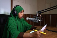 A journalism student practices radio presentation at Radio Himilo of the Mogadishu University in Somalia on April 30, 2017. AMISOM Photo / Ilyas Ahmed. Original public domain image from Flickr