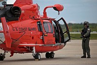 A U.S. Coast Guard HH-65C Dolphin crew chief from Coast Guard Air Station Atlantic City preps the aircraft for takeoff after an alert during a three-day Aeropsace Control Alert CrossTell live-fly training exercise at Atlantic City International Airport, N.J., May 24, 2017.