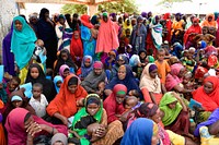 Women and children wait to receive food at an Internally Displaced Persons camp in Doolow, Gedo region, Somalia on June 12, 2017.