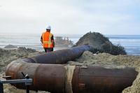 Manson Construction Company pumps material from the Oceanside Harbor entrance channel onto the beach just south of the San Luis Rey River.