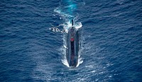 ATLANTIC OCEAN (Aug. 5, 2017) Royal Navy Trafalgar-class submarine HMS Trenchant and Royal Navy Wildcat HMA2, attached to Type 23 frigate HMS Iron Duke (F234), participate in a passenger exchange during exercise Saxon Warrior 2017, Aug. 5. Saxon Warrior is a United States and United Kingdom co-hosted carrier strike group exercise that demonstrates interoperability and capability to respond to crises and deter potential threats.