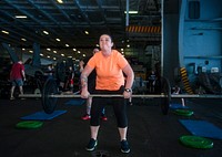 MEDITERRANEAN SEA (June 30, 2017) Aviation Structural Mechanic 2nd Class Katie Fromer participates in an Independence Day workout in the hangar bay aboard the aircraft carrier USS George H.W. Bush (CVN 77).
