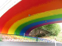 Rainbow Underbelly On A Transit Bridge In North Calgary.