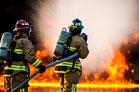 U.S. Air Force Staff Sgt. Joseph Jarrett, left, and Senior Airman Pedro Mora, firefighters assigned to the 349nd Civil Engineer Squadron, Travis Air Force Base Calif., participate in a JP8 fuel burn training scenario at Sparta/Ft.
