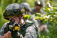 U.S. Air Force Tech. Sgt. Gregory St. Martin, 434th Security Forces Squadron, Grissom AFB, Ind., looks down the scope of his M4carbine rifle equipped with a Multiple Integrated Laser System as he participates in a tactical engagement simulation drill during exercise Patriot Warrior at Young Air Assault Strip, Fort McCoy, Wis., Aug. 18, 2017.