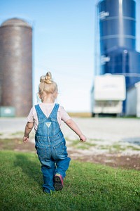 Caelynn Hartman, 2, daughter of Clint and Cassie Hartman, plays on her great grand parents Arnold and Jeanette Brodale's farm outside of Ottosen, Iowa, Sept. 17, 2017.USDA Photo by Preston Keres. Original public domain image from Flickr