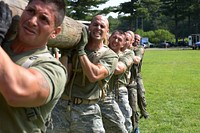 U.S. Air Force Airman 1st Class Emilio Masella, Tech. Sgt. Dedrick Baublitz, Airman 1st Class Adam Roach and other team members perform squats while holding up a telephone pole August 24, 2017, as a part of an obstacle during the Connecticut SWAT Challenge at the West Hartford Reservoir in West Hartford, Conn. This was one of the first of more than 35 obstacles the team faced over the four-mile course.