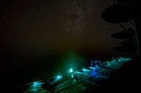 170817-N-AV754-0022 U.S. 5TH FLEET AREA OF OPERATIONS (August 18, 2017) The amphibious assault ship USS Bataan (LHD 5) conducts night operations in the U.S. 5th Fleet area of operations.