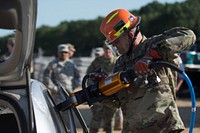 One of the many 372nd Engineer Brigade firefighters tests a piece of extrication equipment on a scrap car during the 372nd Engineer Brigade Firefighter Workshop at Volk Field, Wis. Senior firefighters from across the 372nd Engineer Brigade, as well as representatives from the 420th Engineer Brigade and the 301st Maneuver Enhancement Brigade, came to the workshop designed to standardize all aspects of training, equipment and operations for U.S. Army Reserve firefighters (U.S. Army photo by Sgt. 1st Class Jason Proseus).