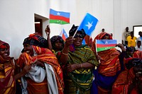 Women wave flags to welcome the Special Representative of the Chairperson of the African Union Commission (SRCC) for Somalia, Ambassador Francisco Caetano Madeira and other officials during a working visit to Barawe, Lower Shabelle region on November 15, 2017.