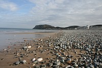 The Beach at Llandudno...and above the pebbles the whole beach wasn't looking bad either.It's a really nice place, and a damn shame that I associate it with someone I really, really don't like.Ah well. Time is a great healer. Original public domain image from Flickr
