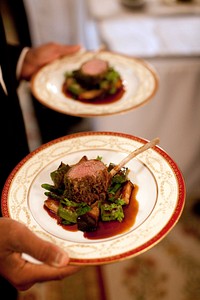 A plate of food is carried by a White House butler during a dinner hosted by President Barack Obama in the Old Family Dining Room at the White House, June 24, 2009.