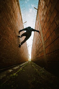 Man jumping between buildings. Free public domain CC0 photo.