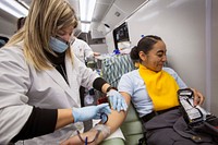 Phlebotomist Sandra Rodriguez, left, Miller Keystone Blood Center, Ewing, N.J., removes a blood donation needle from Cadet Gabrielle Reyes’ arm during a blood drive at the New Jersey National Guard Youth ChalleNGe Academy at Joint Base McGuire-Dix-Lakehurst, N.J., Jan. 24, 2018. The Youth ChalleNGe Academy is an education program that provides 16 to 18 year-old high school dropouts the opportunity to undergo an intense 22-week structured residential program in a quasi-military environment and prepares them for the GED exam. (New Jersey National Guard photo by Mark C. Olsen). Original public domain image from Flickr