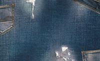 Close up of faded texture of a denim jeans back pocket