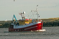 Red fishing boat sailing. Free public domain CC0 photo.