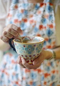 Free hand stirring a teaspoon in a cup of coffee photo, public domain drink CC0 image.