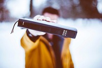 Free man holding black book in winter image, public domain people CC0 photo.