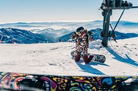 Free person on snowboard on knees in snow mountain photo, public domain sport CC0 image.