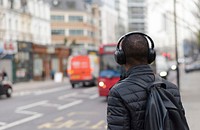 Free black man waiting for bus on street image, public domain people CC0 photo.