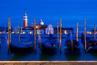 A row of gondolas in water. Free public domain CC0 photo.