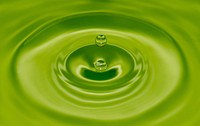 Green waterdrop on water. Free public domain CC0 photo.